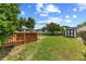 A large, open backyard features a wooden deck and storage shed at 3101 Riverbrooke Dr, Raleigh, NC 27610