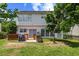 View of the home's backyard featuring the wood deck, patio, and lush green grass at 3101 Riverbrooke Dr, Raleigh, NC 27610