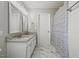 Full bathroom with white marble floors, granite counters, and a shower/tub combo at 3101 Riverbrooke Dr, Raleigh, NC 27610
