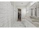 Bright bathroom featuring a granite-topped vanity, large mirror, and marble floors at 3101 Riverbrooke Dr, Raleigh, NC 27610