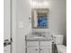 Half bathroom featuring a granite topped vanity and unique mirror at 3101 Riverbrooke Dr, Raleigh, NC 27610