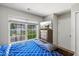 Bright bedroom featuring a large window with blinds, a dresser, and a mounted television at 3101 Riverbrooke Dr, Raleigh, NC 27610