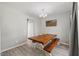 Dining room with a large table, bench seating, wood-look flooring, and contemporary chandelier at 3101 Riverbrooke Dr, Raleigh, NC 27610