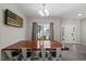 Bright dining room with chandelier, gray walls, and a large window for natural light at 3101 Riverbrooke Dr, Raleigh, NC 27610