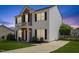 Charming two-story home features a red door, brick accents, a small balcony, and a well-maintained lawn at 3101 Riverbrooke Dr, Raleigh, NC 27610