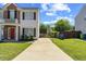 View of the front of a charming two-story home with a long driveway and well-maintained lawn at 3101 Riverbrooke Dr, Raleigh, NC 27610