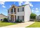 Inviting two-story home with a balcony, manicured lawn, and a spacious driveway at 3101 Riverbrooke Dr, Raleigh, NC 27610