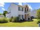 Charming two-story home features a red door, brick accents, a small balcony, and a well-maintained lawn at 3101 Riverbrooke Dr, Raleigh, NC 27610
