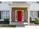 Welcoming front entrance with red door, brick facade and white trim and columns at 3101 Riverbrooke Dr, Raleigh, NC 27610