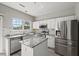 Bright kitchen with stainless steel appliances and a center island featuring granite countertops at 3101 Riverbrooke Dr, Raleigh, NC 27610