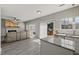 Well-lit living space with fireplace and view into a modern kitchen with stainless appliances at 3101 Riverbrooke Dr, Raleigh, NC 27610