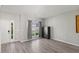 Living room with hardwood floors, gun safe, and ample natural light at 3101 Riverbrooke Dr, Raleigh, NC 27610