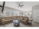Open-concept living room with hardwood floors, white kitchen, and abundant natural light at 3101 Riverbrooke Dr, Raleigh, NC 27610