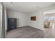 Spacious living room with hardwood floors, gun safe, and ample natural light at 3101 Riverbrooke Dr, Raleigh, NC 27610