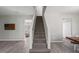 Bright staircase with carpeted steps and white railing in a modern home at 3101 Riverbrooke Dr, Raleigh, NC 27610