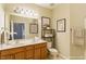 Bathroom with double sinks, warm wood cabinets, and decorative mirrors creating a functional and inviting space at 320 Madres Ln, Morrisville, NC 27560