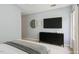 Modern bedroom featuring a sleek black dresser, wall-mounted TV, and minimalist decor for contemporary living at 320 Madres Ln, Morrisville, NC 27560