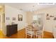 Well-lit dining area with hardwood floors, a charming chandelier, and space for Gathering meals at 320 Madres Ln, Morrisville, NC 27560