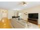 Bright, open-concept living room boasts hardwood floors and a ceiling fan for added comfort at 320 Madres Ln, Morrisville, NC 27560