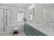 Bright bathroom featuring double sinks, modern vanity, soaking tub, and a glass-enclosed shower at 3310 Mission Olive Pl, New Hill, NC 27562