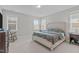 Bright bedroom with multiple windows and floral bedding creates a serene atmosphere at 3310 Mission Olive Pl, New Hill, NC 27562
