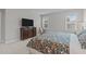 Comfortable bedroom with floral bedding, a rocking chair, and abundant natural light at 3310 Mission Olive Pl, New Hill, NC 27562