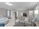 A bedroom area showing the bed, seating area and bookshelf for additional storage options at 3310 Mission Olive Pl, New Hill, NC 27562