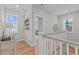 Upstairs hallway with hardwood floors and natural light, offering a bright and airy feel at 3310 Mission Olive Pl, New Hill, NC 27562