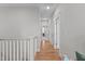 Upstairs hallway with hardwood floors and neutral walls leading to various rooms at 3310 Mission Olive Pl, New Hill, NC 27562