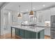 Stylish kitchen with white cabinets, a center island, and stainless steel appliances at 3310 Mission Olive Pl, New Hill, NC 27562