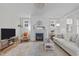 Living room boasts neutral walls, a decorative fireplace, a ceiling fan, and lots of natural light at 3310 Mission Olive Pl, New Hill, NC 27562