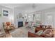 A traditional-style living room features a fireplace, neutral walls, lots of natural light, and traditional furnishings at 3310 Mission Olive Pl, New Hill, NC 27562