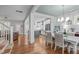 Open-concept living space featuring hardwood floors and seamless flow to the kitchen at 3310 Mission Olive Pl, New Hill, NC 27562
