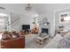 Traditional living room features a fireplace, lots of seating, neutral walls, and access to the staircase at 3310 Mission Olive Pl, New Hill, NC 27562