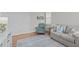 Bright sitting area with grey sofa, comfortable chair, and hardwood floor at 3310 Mission Olive Pl, New Hill, NC 27562