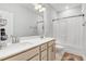 Bright bathroom with double vanity, large mirror, and tub shower combination at 333 Natsam Woods Way, Wake Forest, NC 27587