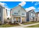 Beautiful two-story home featuring stone accents, a welcoming front porch, and manicured landscaping at 333 Natsam Woods Way, Wake Forest, NC 27587