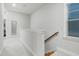 Upstairs hallway with carpet floors and natural light from window on the right at 333 Natsam Woods Way, Wake Forest, NC 27587