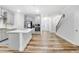 Stylish kitchen with stainless appliances, white cabinetry, a center island, and an adjacent dining area at 333 Natsam Woods Way, Wake Forest, NC 27587