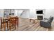 Open-concept living room with a fireplace, wood floors, and a seamless flow to the kitchen and dining area at 333 Natsam Woods Way, Wake Forest, NC 27587