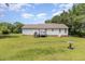 A view of the home's back exterior shows a spacious yard with a deck at 3336 Piney Grove Wilbon Rd, Fuquay Varina, NC 27526