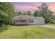 Charming single-story home with a well-manicured lawn and attached garage at 3336 Piney Grove Wilbon Rd, Fuquay Varina, NC 27526