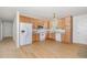 Bright kitchen with wood cabinets, white appliances, and vinyl flooring at 3336 Piney Grove Wilbon Rd, Fuquay Varina, NC 27526