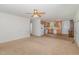 Open-concept living area leading to a kitchen with wood cabinets and white appliances at 3336 Piney Grove Wilbon Rd, Fuquay Varina, NC 27526