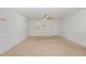 Bright and airy living room featuring neutral carpet and a ceiling fan at 3336 Piney Grove Wilbon Rd, Fuquay Varina, NC 27526