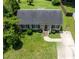 Aerial view of a home with a well-manicured lawn, driveway with basketball hoop, and mature trees providing shade at 3624 Meadow Creek Ln, Raleigh, NC 27616