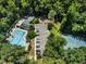 Community aerial view showcasing a pool, tennis court, playground, parking, and lush greenery at 3811 Cottonwood Dr, Durham, NC 27705
