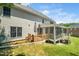 Home exterior featuring a screened porch, deck, and a well-maintained lawn at 3811 Cottonwood Dr, Durham, NC 27705