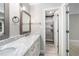 Bathroom featuring a double vanity with marble countertops and a tiled shower at 3811 Cottonwood Dr, Durham, NC 27705