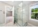 Bright bathroom featuring a large glass shower and a window with a leafy view at 3811 Cottonwood Dr, Durham, NC 27705